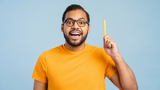 Man holding up a pencil with an idea