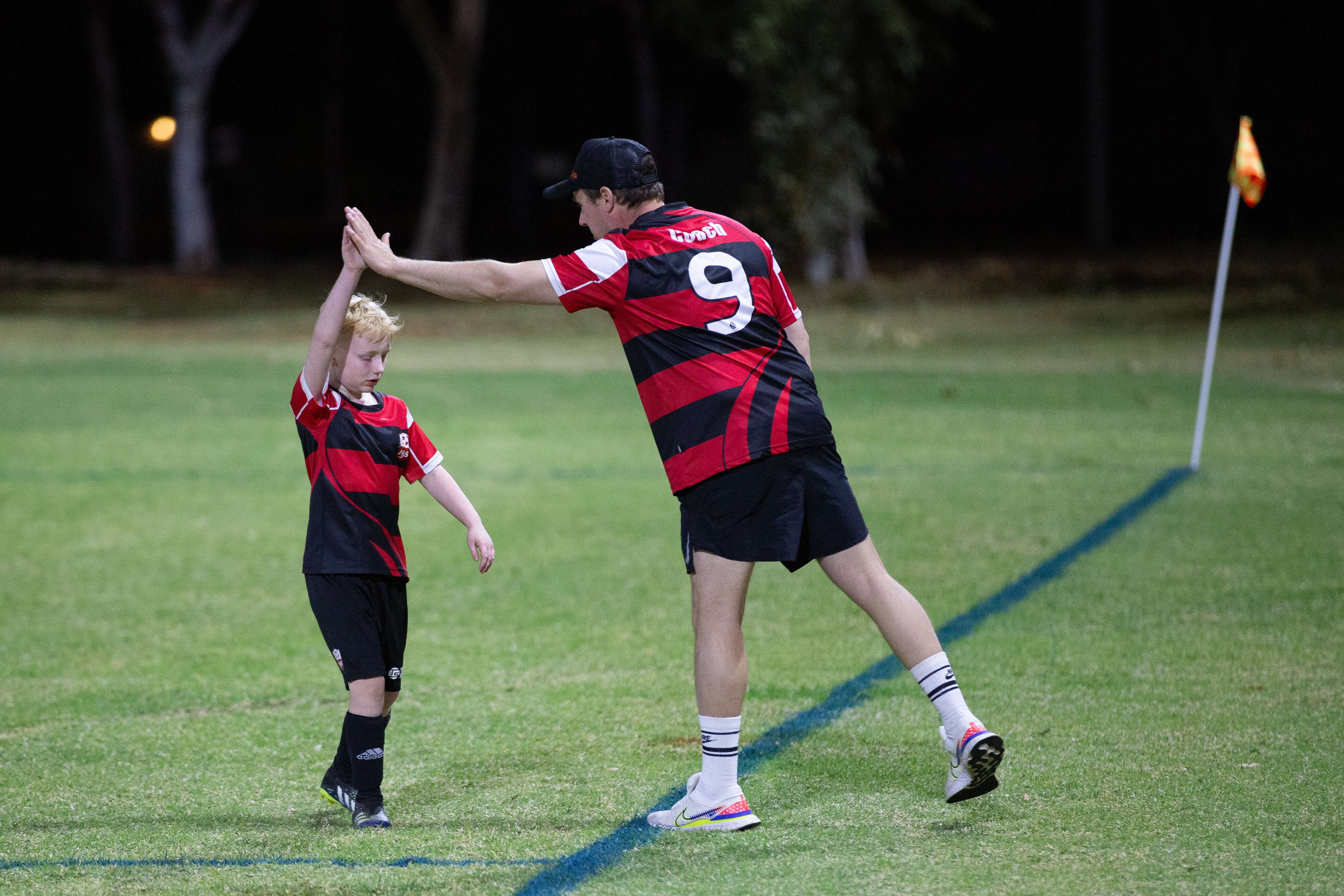 coach high fiving a young player